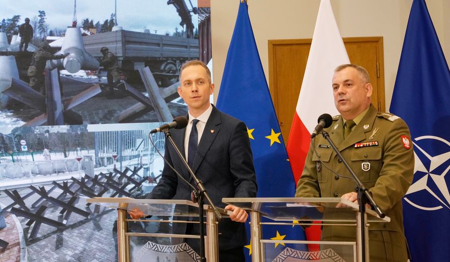 FILE - Gen. Wieslaw Kukula, the Polish armed forces chief of staff, right, and Deputy Defense Minister Cezary Tomczyk, left, discuss strengthening security of Poland's border, May, 27, 2024, in Warsaw, Poland. (AP Photo/Czarek Sokolowski, File)