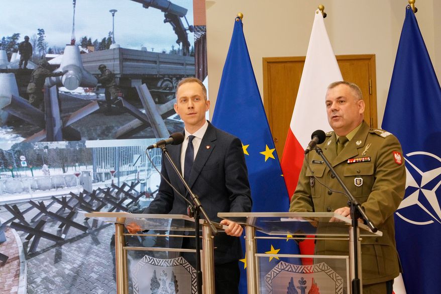 FILE - Gen. Wieslaw Kukula, the Polish armed forces chief of staff, right, and Deputy Defense Minister Cezary Tomczyk, left, discuss strengthening security of Poland's border, May, 27, 2024, in Warsaw, Poland. (AP Photo/Czarek Sokolowski, File)