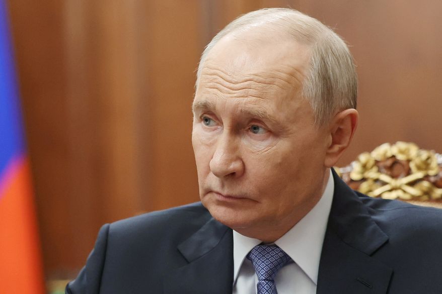 Russian President Vladimir Putin speaks with Sergei Menyailo, the North Ossetia-Alania Republic Head, during their meeting at the Kremlin in Moscow, Tuesday, June 16, 2026. (Vyacheslav Prokofyev, Sputnik, Kremlin Pool Photo via AP)