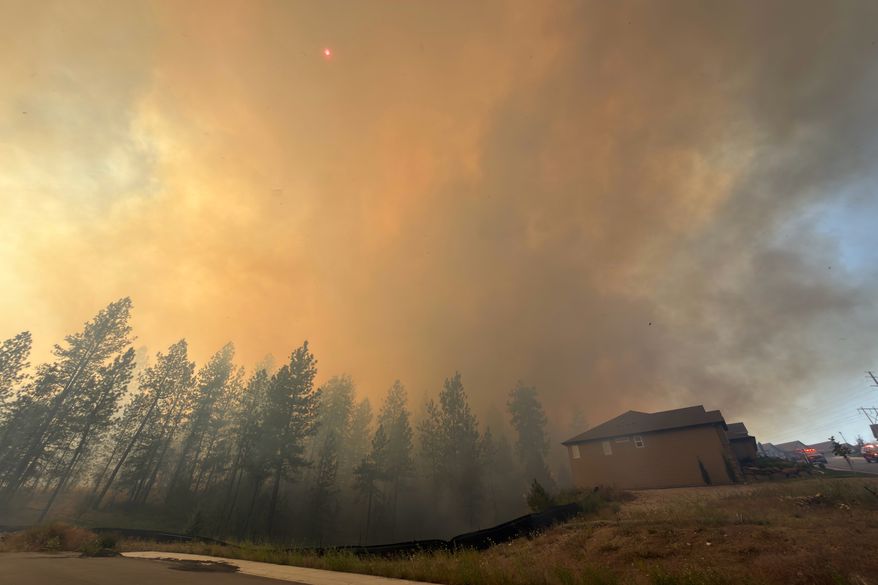 This photo provided by Spokane Fire District 9 shows the Upriver Fire burning northeast of Spokane, Wash., on Tuesday, June 16, 2026. (Robert Gray/Spokane Fire District 9 via AP)