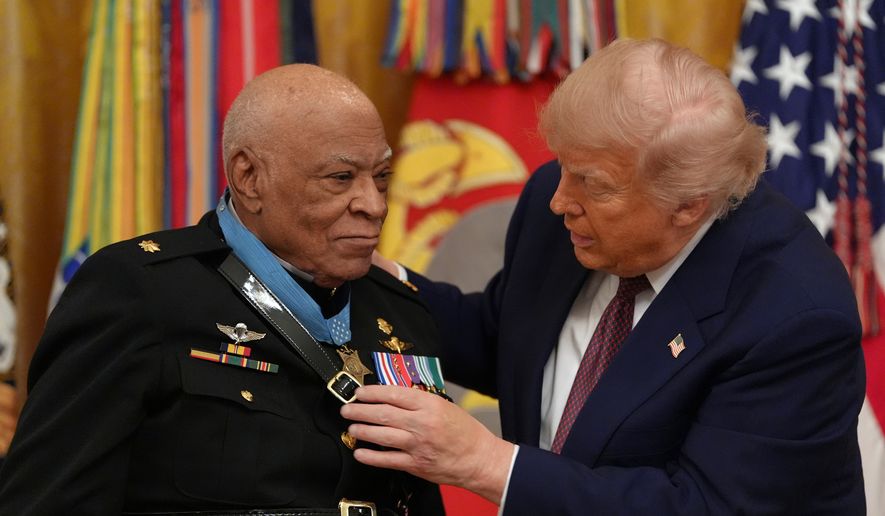 President Donald Trump, right, awards retired Marine Maj. James Capers the Medal of Honor in the East Room of the White House, Thursday, June 18, 2026, in Washington. (AP Photo/Jacquelyn Martin)