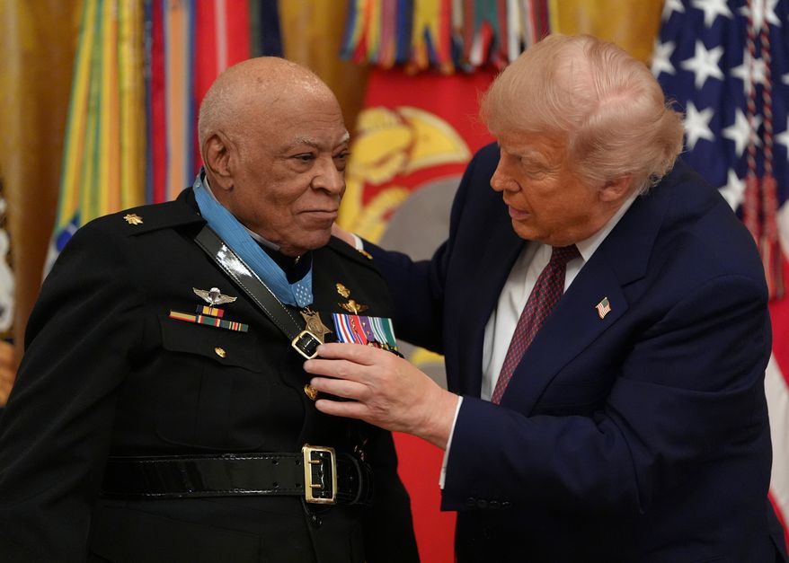 President Donald Trump, right, awards retired Marine Maj. James Capers the Medal of Honor in the East Room of the White House, Thursday, June 18, 2026, in Washington. (AP Photo/Jacquelyn Martin)
