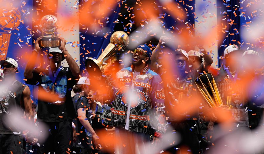 New York Knicks center Karl-Anthony Towns, center, celebrates with teammates during the New York Knicks' NBA championship parade Thursday, June 18, 2026, in New York. (AP Photo/Yuki Iwamura)