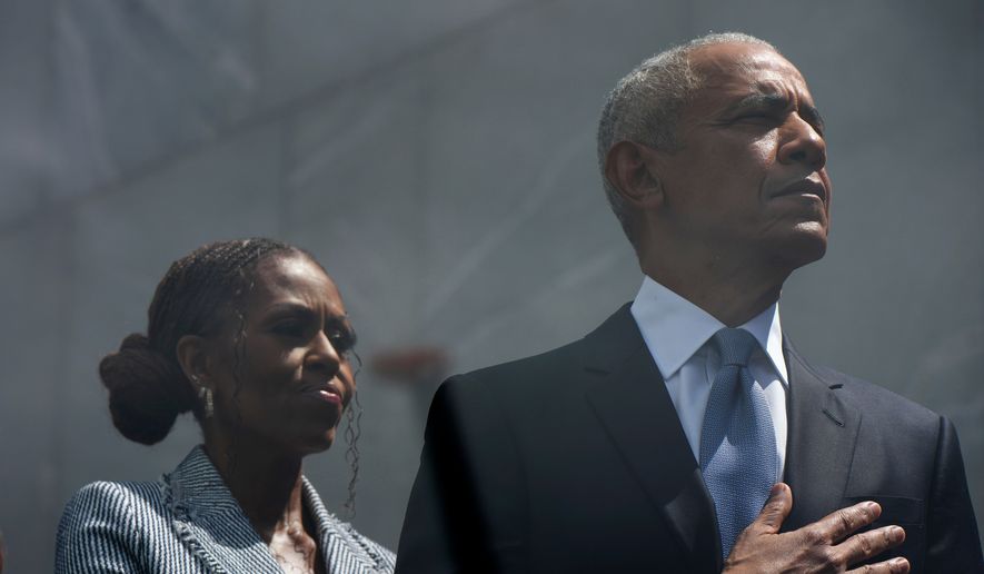 Former President Barack Obama and former First Lady Michelle Obama on stage during the dedication ceremony for the Obama Presidential Center, Thursday, June 18, 2026, in Chicago. (AP Photo/Alex Brandon)