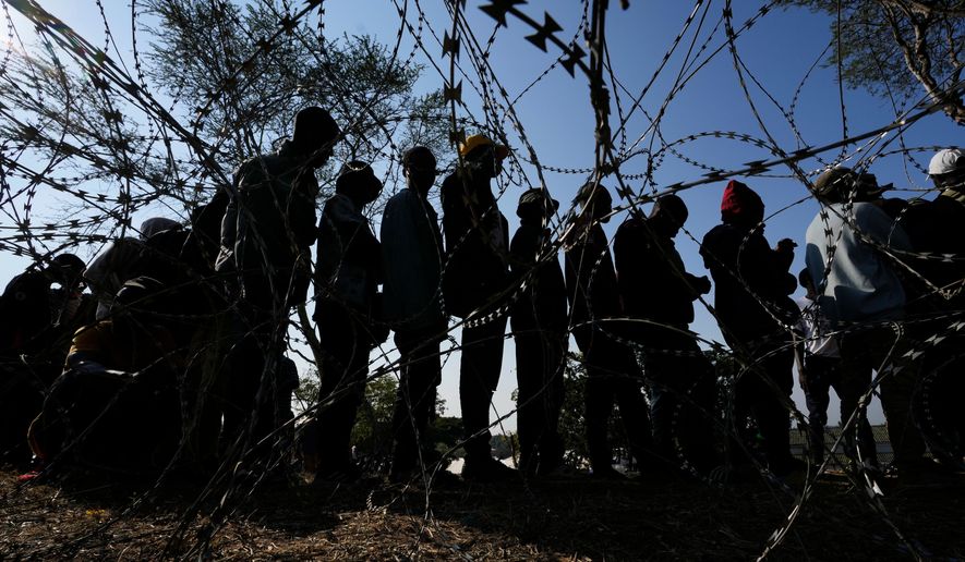 Malawian migrants stand in a queue for their deportation at a temporary centre, in Durban, South Africa, Thursday, June 18, 2026. (AP Photo/Themba Hadebe)