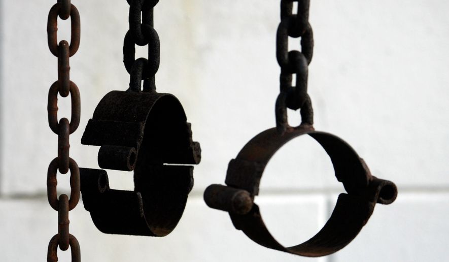 These shackles, shown on the property of St. Augustine Church in New Orleans on March 6, 2008, are part of the shrine dedicated to the unknown slave. (AP Photo/Bill Haber, File)