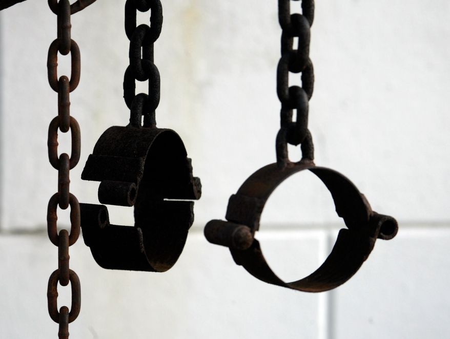 These shackles, shown on the property of St. Augustine Church in New Orleans on March 6, 2008, are part of the shrine dedicated to the unknown slave. (AP Photo/Bill Haber, File)