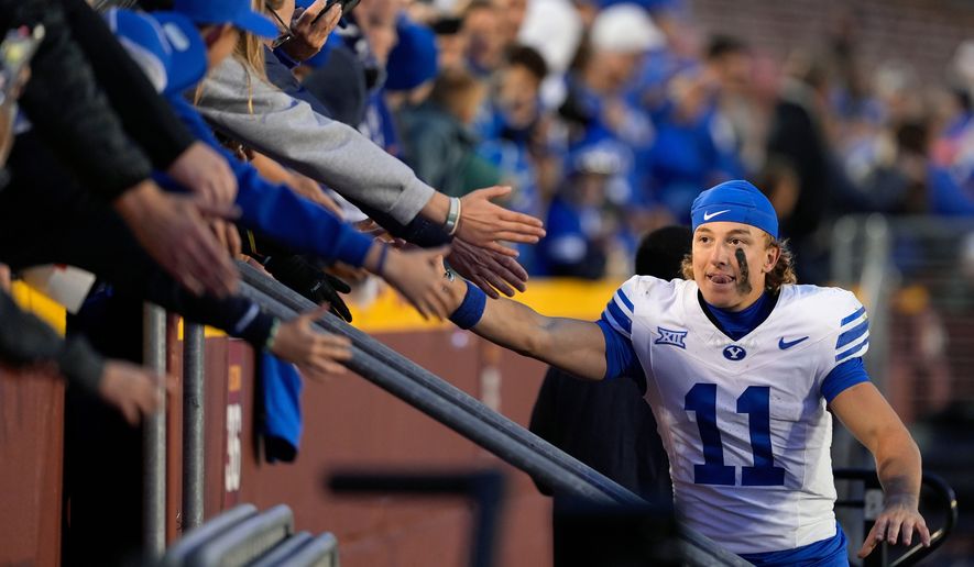 BYU wide receiver Parker Kingston (11) celebrates with fans after a win over Iowa State in an NCAA college football game, Oct. 25, 2025, in Ames, Iowa. (AP Photo/Matthew Putney, File)