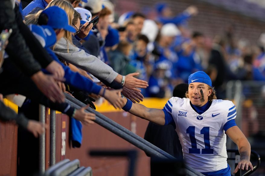 BYU wide receiver Parker Kingston (11) celebrates with fans after a win over Iowa State in an NCAA college football game, Oct. 25, 2025, in Ames, Iowa. (AP Photo/Matthew Putney, File)