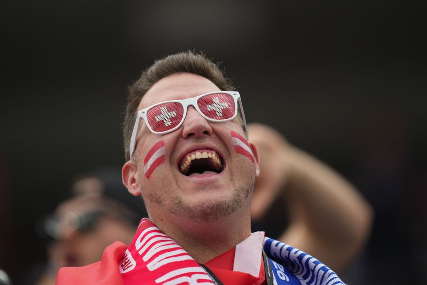 A fan of Switzerland cheers prior to the World Cup Group B soccer match between Switzerland and Bosnia in Inglewood, Calif., near Los Angeles, Thursday, June 18, 2026. (AP Photo/Andre Penner)