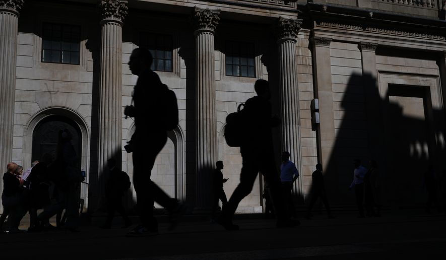 FILE -Pedestrians walk past the Bank of England in London, April 30, 2026. (AP Photo/Kirsty Wigglesworth, File)