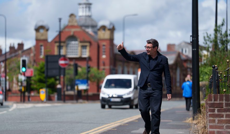 Andy Burnham gives a thumbs up to supporters during a campaign visit to Ashton-in-Makerfield before the forthcoming by-election, in Manchester, England, Tuesday, June 9, 2026. CORRECTION: corrects family name to Burnham instead of Bunham (AP Photo/Jon Super)