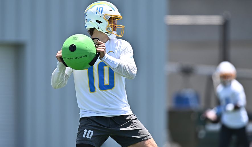 Los Angeles Chargers quarterback Justin Herbert runs a drill during the NFL football team's practice, Monday, June 8, 2026, in El Segundo, Calif. (AP Photo/William Liang)