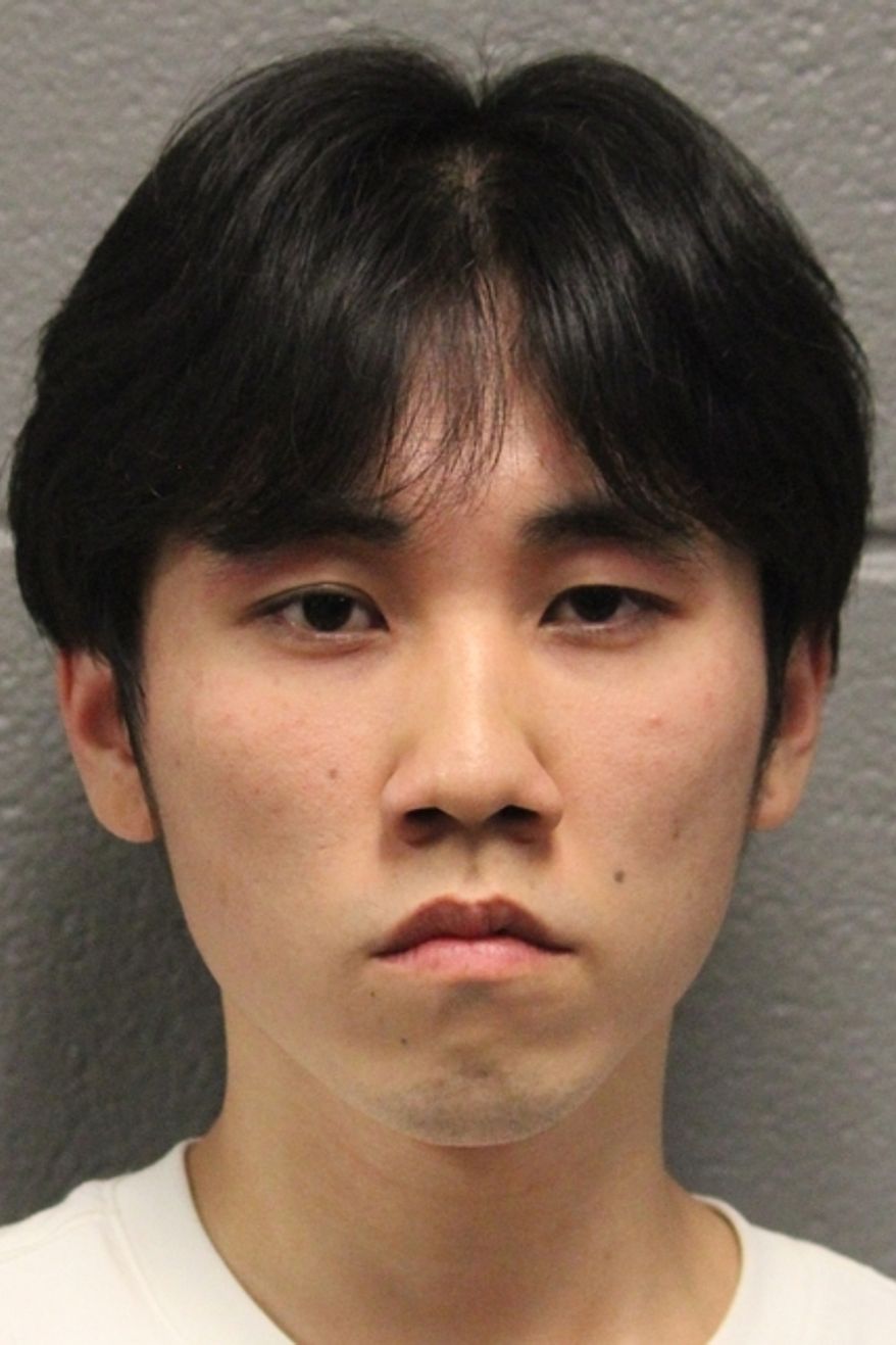 This booking photo released by the Chicago Police Department on Wednesday, June 17, 2026, shows Merlin Lu, who has been charged with a hate crime and other offenses in the burning of a cross in Chicago's Grant Park. (Chicago Police Department via AP)