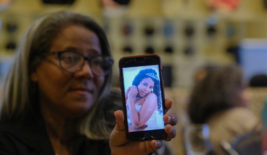 FILE - Rosa Hernández shows a photo of her late daughter Rosaura Almonte in Santo Domingo, Dominican Republic, Dec. 10, 2023. Hernández asked for an exception for her daughter to get an abortion in order to use chemotherapy as her leukemia treatment, but was denied because that would put the fetus at risk of death in the Dominican Republic where abortion is criminalized without exceptions. Both her daughter and daughter's 13-week-old fetus died in 2012. (AP Photo/Ricardo Hernandez, File)