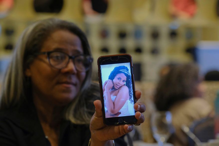 FILE - Rosa Hernández shows a photo of her late daughter Rosaura Almonte in Santo Domingo, Dominican Republic, Dec. 10, 2023. Hernández asked for an exception for her daughter to get an abortion in order to use chemotherapy as her leukemia treatment, but was denied because that would put the fetus at risk of death in the Dominican Republic where abortion is criminalized without exceptions. Both her daughter and daughter's 13-week-old fetus died in 2012. (AP Photo/Ricardo Hernandez, File)