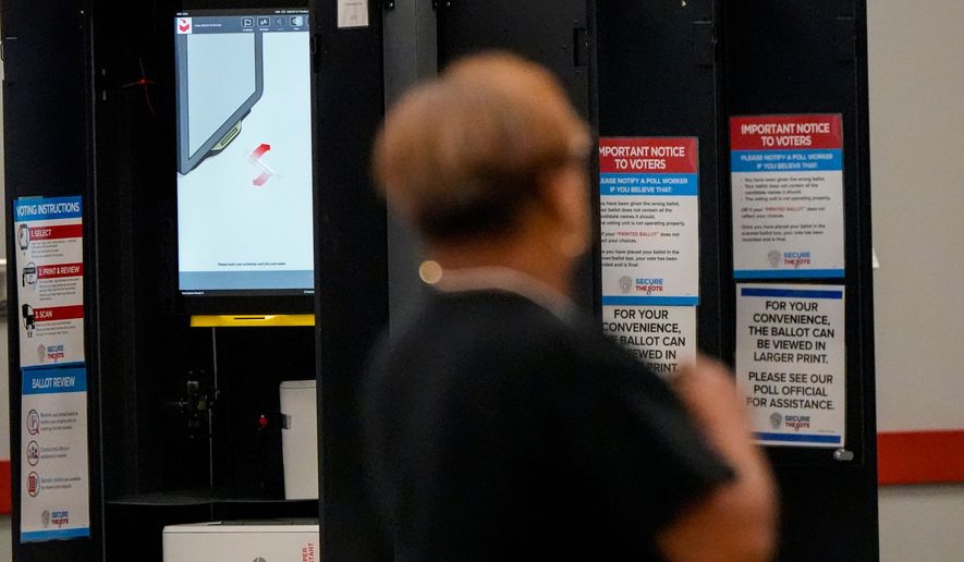 A voting machine is seen as people vote in a runoff election at the C.T. Martin Recreation Center, Tuesday, June 16, 2026, in Atlanta. (AP Photo/Mike Stewart)