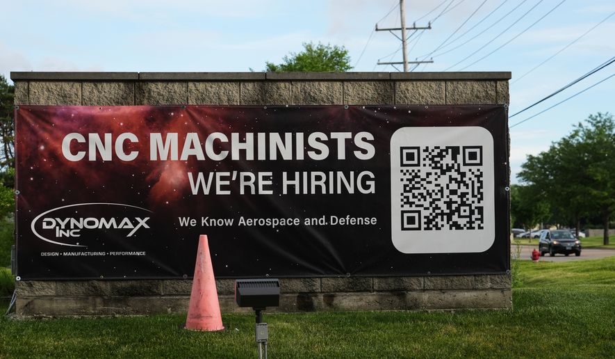 A hiring sign is seen outside of a company in Wheeling, Ill., Monday, June 8, 2026. (AP Photo/Nam Y. Huh)