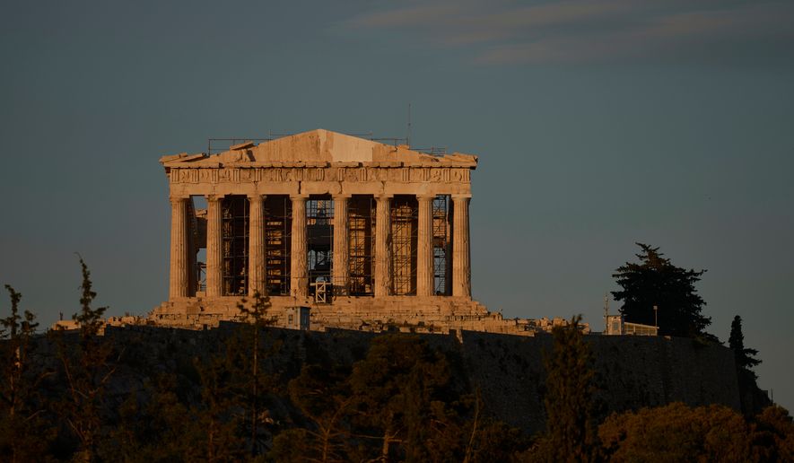 The Parthenon's restored west pediment is seen atop the Acropolis in Athens, Thursday, June 18, 2026, after Greece's Culture Ministry unveiled the temple's western side in its most complete form in more than 200 years. (AP Photo/Petros Giannakouris)