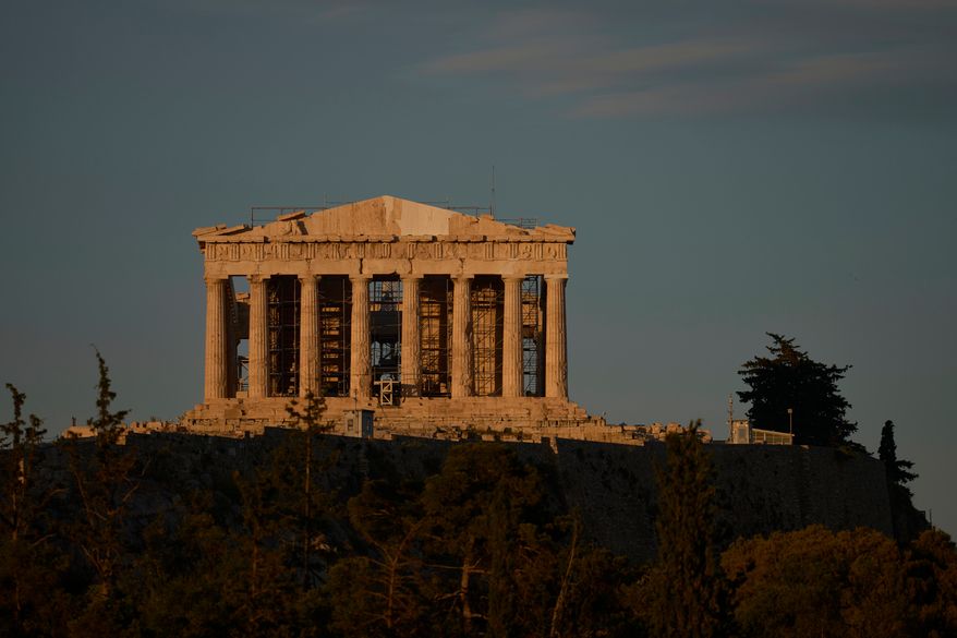 The Parthenon's restored west pediment is seen atop the Acropolis in Athens, Thursday, June 18, 2026, after Greece's Culture Ministry unveiled the temple's western side in its most complete form in more than 200 years. (AP Photo/Petros Giannakouris)