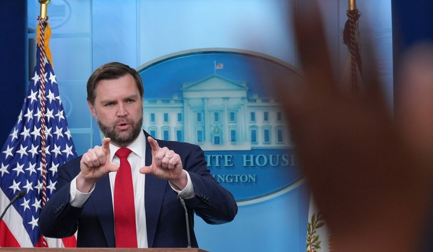 A reporter raises a hand to ask a question as Vice President JD Vance speaks in the James Brady Press Briefing Room at the White House, Thursday, June 18, 2026, in Washington. (AP Photo/Jacquelyn Martin)