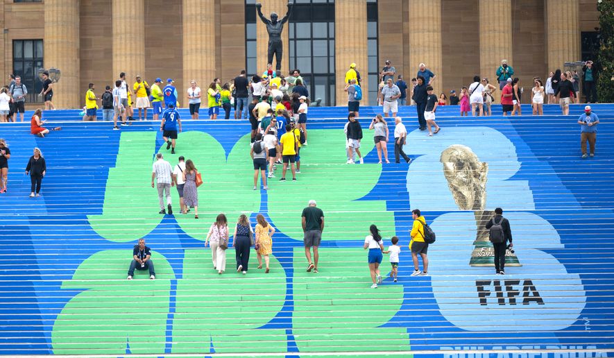 Brazilian and other soccer fans climb the steps leading to the Rocky statue, marked with a FIFA World Cup logo, in Philadelphia, on Thursday, June 18, 2026, ahead of Friday's FIFA World Cup Group C match between Brazil and Haiti. (Jose F. Moreno/The Philadelphia Inquirer via AP)/The Philadelphia Inquirer via AP)