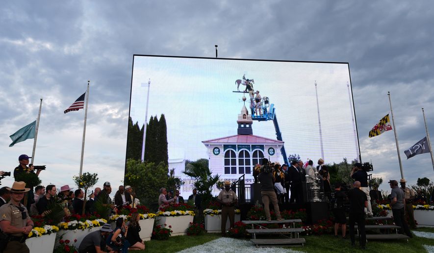 FILE - A broadcast shows staff painting the new colors of Paco Lopez and Napoleon Solo on the Pimlico weather vane after they won the 151st running of the Preakness Stakes horse race, May 16, 2026, at Laurel Park in Laurel, Md. (AP Photo/Julia Demaree Nikhinson, File)