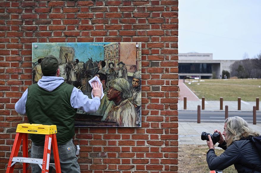 Panels that were part of an exhibit on slavery at the President's House Site in Philadelphia are put back Thursday, Feb. 19, 2026. (AP Photo/Joe Lamberti) **FILE**