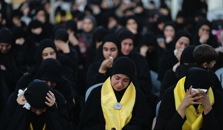 Women weep and mourn during a sermon marking the third day of Ashoura, the Shiite Muslim commemoration of the 7th-century death of Imam Hussein, the grandson of the Prophet Muhammad, in the southern port city of Tyre, Lebanon, Friday, June 19, 2026. (AP Photo/Hassan Ammar)