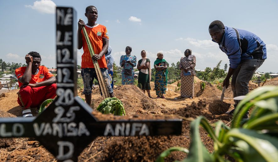 Relatives of Vanisa Anifa, a 6-month-old orphaned girl who died of Ebola, attend her burial, in Bunia, Congo, Friday, June 19, 2026. (AP Photo/Moses Sawasawa)