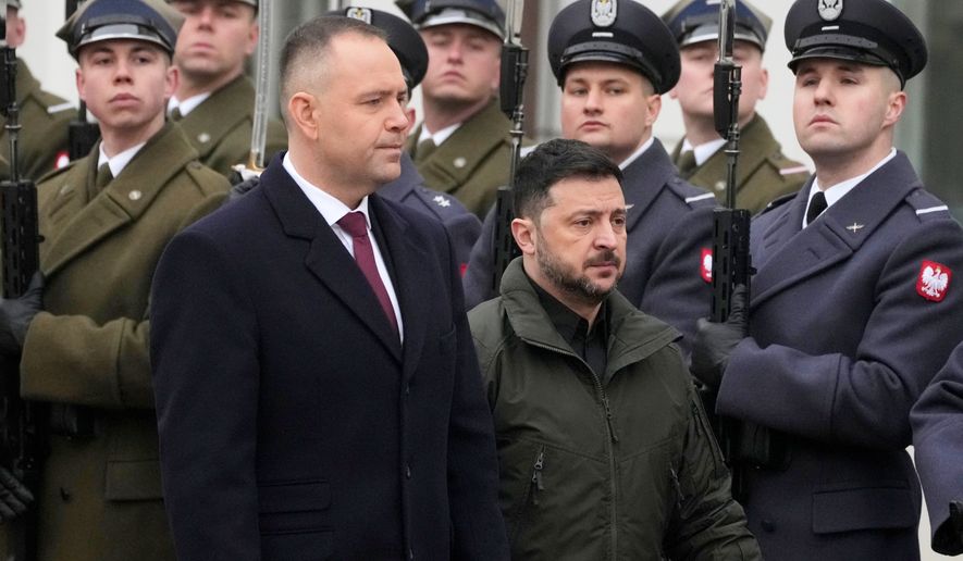 Polish President Karol Nawrocki, left, and Ukrainian President Volodymyr Zelenskyy attend an official welcome ceremony before their meeting at the Presidential Palace in Warsaw, Poland, Dec. 19, 2025. (AP Photo/Czarek Sokolowski, File)