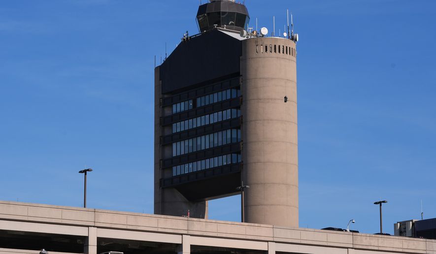 FILE - The control tower at Logan Airport, on Dec. 9, 2025, in Boston. (AP Photo/Charles Krupa, File)