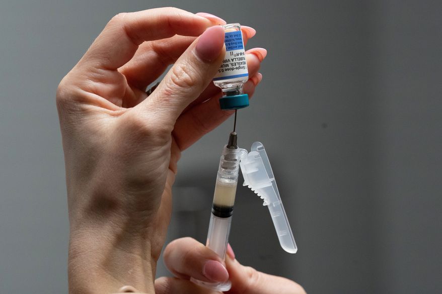 Lauren Ellenburg, a nurse, prepares a combination measles, mumps and rubella vaccine for a patient at Tiger Pediatrics in Easley, S.C., March 17, 2026. (AP Photo/Mary Conlon, File)