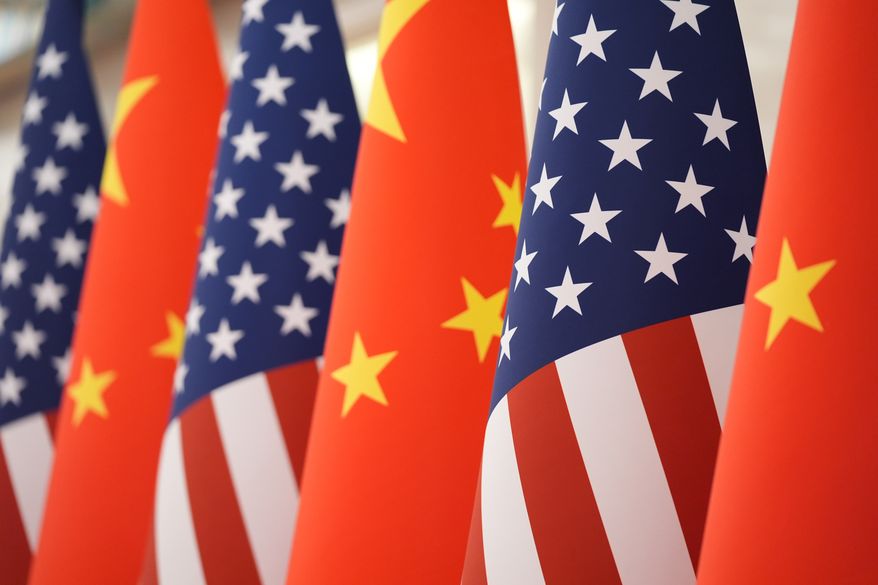 FILE - The U.S. and Chinese flag at the Great Hall of the People prior to the state dinner of President Donald Trump and Chinese President Xi Jinping on May 14, 2026, in Beijing. (AP Photo/Mark Schiefelbein, File)
