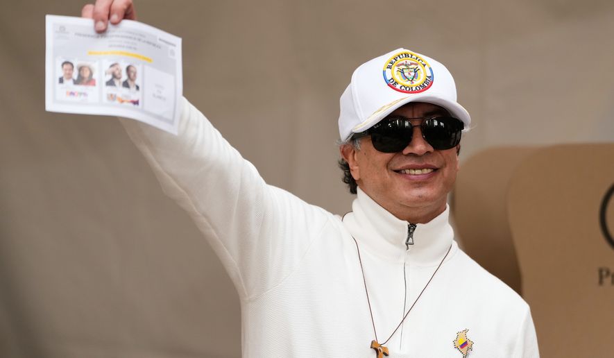 Colombian President Gustavo Petro shows a ballot during the runoff election in Bogota, Colombia, Sunday, June 21, 2026. (AP Photo/Fernando Vergara)