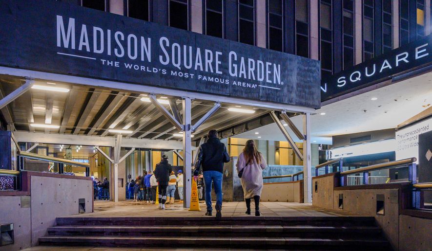 Fans line up outside Madison Square Garden before an NBA basketball game in New York, Feb. 23, 2021. (AP Photo/Brittainy Newman, File)