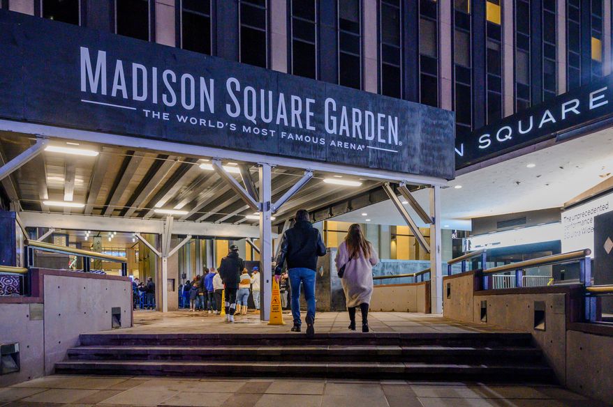 Fans line up outside Madison Square Garden before an NBA basketball game in New York, Feb. 23, 2021. (AP Photo/Brittainy Newman, File)