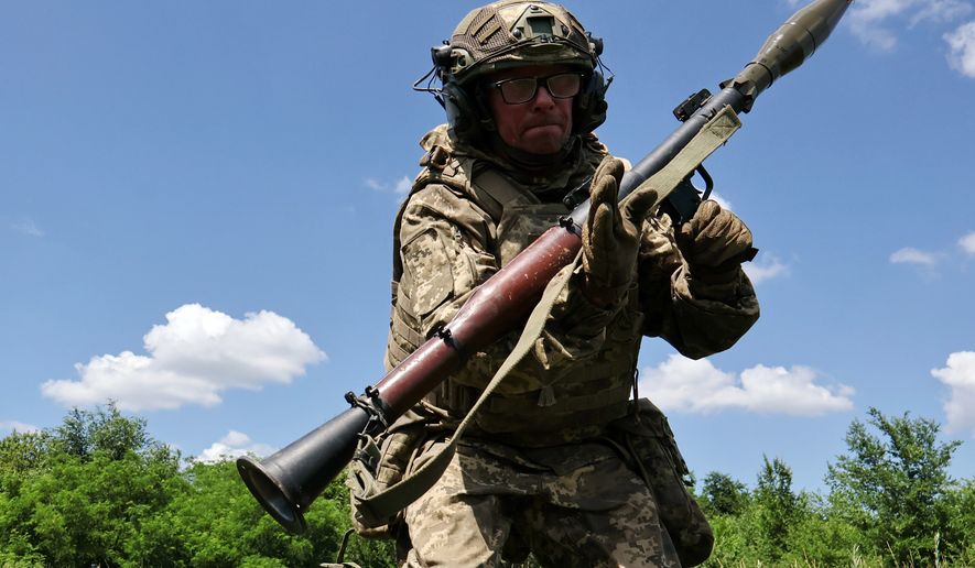 In this photo provided by Ukraine's 65th Mechanized Brigade press service, a soldier practices military skills at a training ground near the frontline in the Zaporizhzhia region, Ukraine, Saturday, June 20, 2026. (Andriy Andriyenko/Ukraine's 65th Mechanized Brigade via AP)