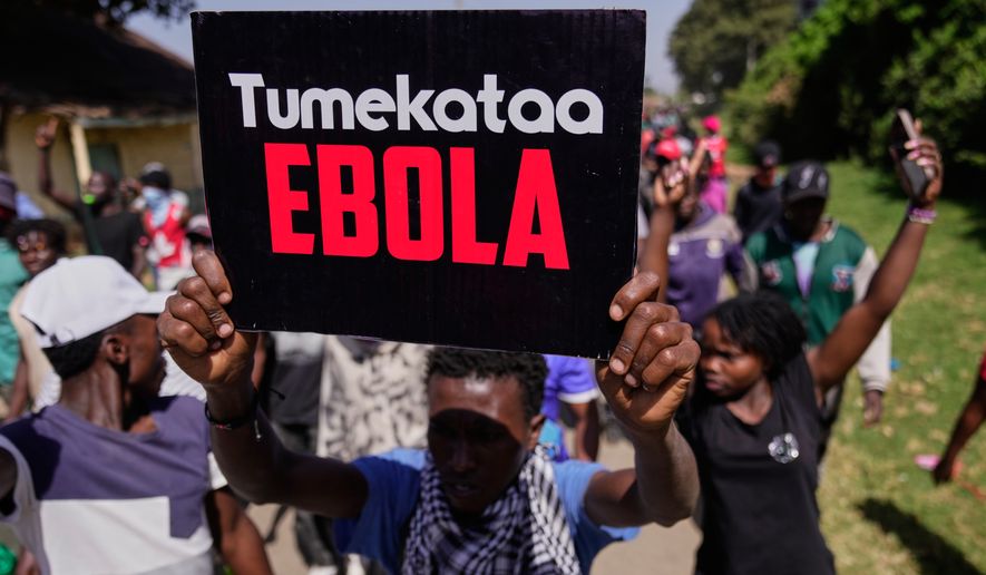 A protester holds a placard reading "Tumekataa Ebola" (We refuse Ebola) during a demonstration against a proposed Ebola quarantine center to be established by the United States at Laikipia Air Base in Nanyuki, Kenya, Tuesday, June 9, 2026. (AP Photo/Brian Inganga)