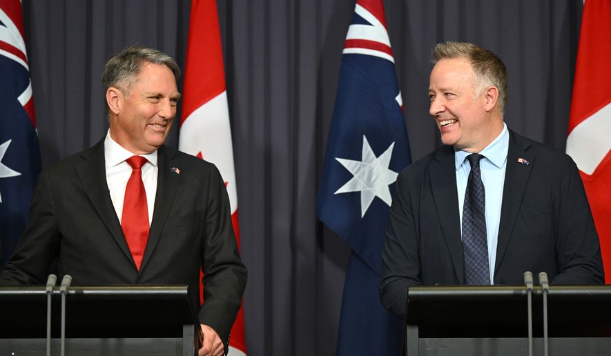 Australian Defense Minister Richard Marles, left, and Canada's Secretary of State Stephen Fuhr speak to the media after signing an agreement on export of an Over-the-Horizon Radar system at Parliament House in Canberra, Australia, Monday, June 22, 2026. (Lukas Coch/AAP Image via AP)