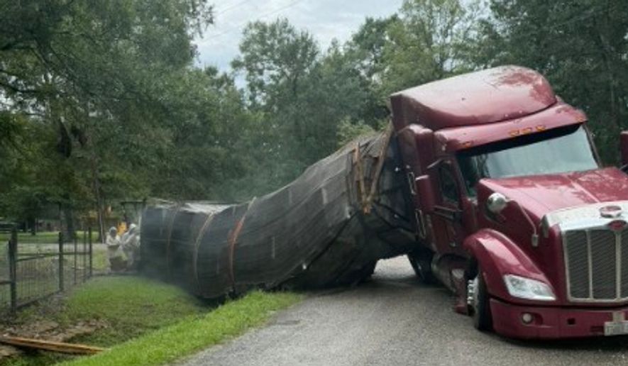 A semitrailer carrying about 400 beehives toppled over, allowing millions of bees to escape into a rural neighborhood in Orange, Texas, on June 21, 2026. (Christie Ray/Queen Bee Supply via AP)