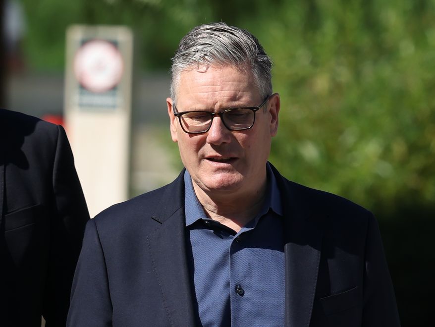 Britain's Prime Minister Keir Starmer walks, as he visits a housing development in north London, Friday, June 19, 2026. (Peter Macdiarmid/Pool Photo via AP)