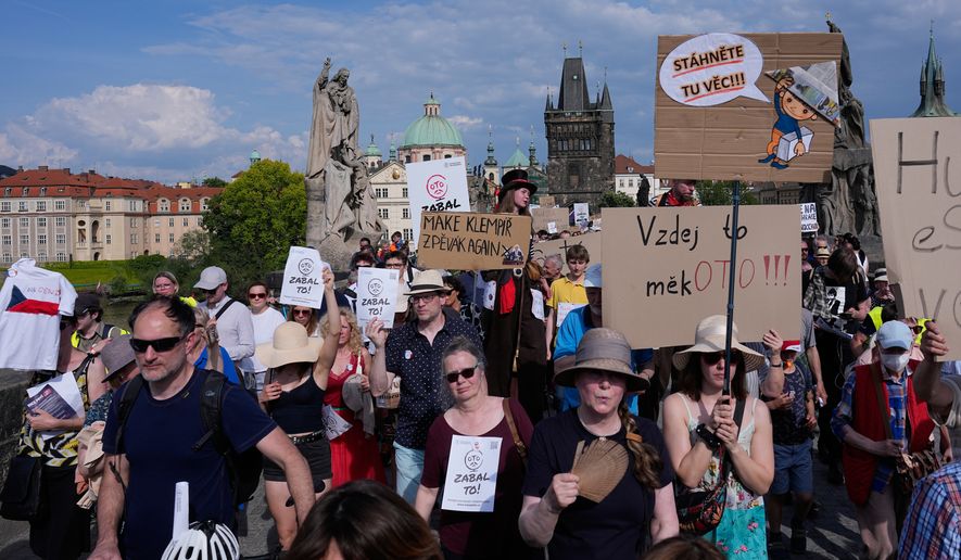 Thousands of people march to protest against a government plan to change public broadcaster funding in Prague, Czech Republic, Sunday, May 24, 2026. (AP Photo/Petr David Josek)