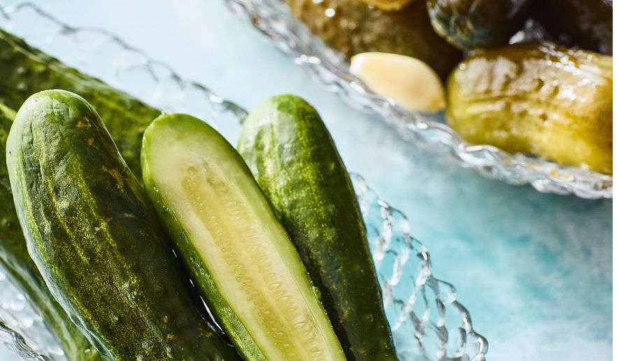 This image released by Voracious shows a recipe for half sour pickles from the cookbook "Cold Canning" by Bruce Weinstein and Mark Scarbrough. (Eric Medsker/Voracious via AP)