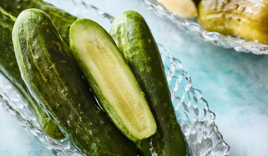This image released by Voracious shows a recipe for half sour pickles from the cookbook "Cold Canning" by Bruce Weinstein and Mark Scarbrough. (Eric Medsker/Voracious via AP)