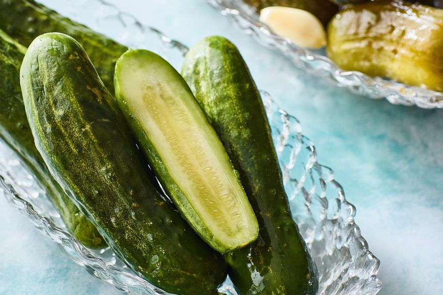 This image released by Voracious shows a recipe for half sour pickles from the cookbook "Cold Canning" by Bruce Weinstein and Mark Scarbrough. (Eric Medsker/Voracious via AP)