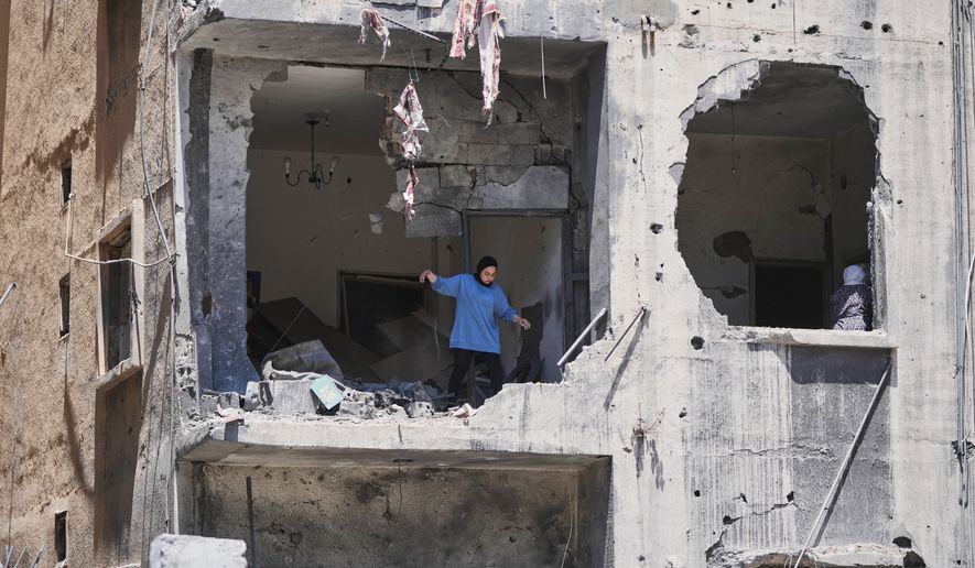 A woman walks through her apartment damaged in Israeli strikes in the southern port city of Tyre, Lebanon, Thursday, June 18, 2026. (AP Photo/Hassan Ammar)