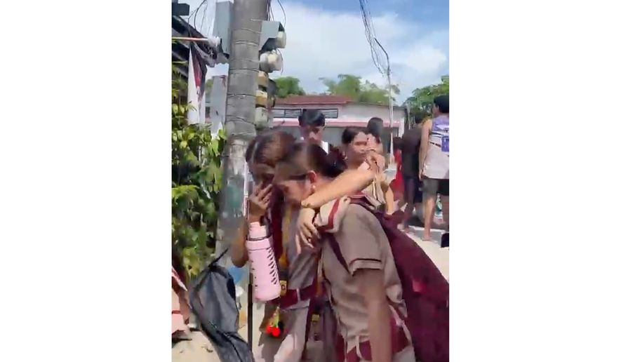 In this photo taken from a video, students react after a shooting incident at the San Jose National High School in Tacloban city, Philippines Monday, June 22, 2026. (James Daantos via AP Photo)