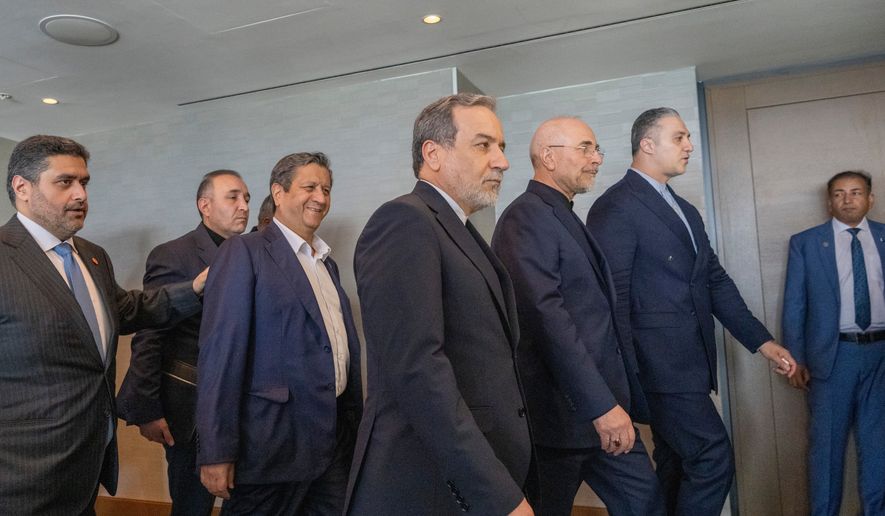 Minister of Foreign Affairs of Iran Abbas Araghchi, third from right, and Speaker of the Islamic Parliament of Iran Mohammed Bagher Ghalibaf, second from right, with the Delegation of Iran at the Lake Lucerne Summit at the Buergenstock resort in Obbuergen, near Lucerne, Switzerland, Sunday, June 21, 2026. (Urs Flueeler, Pool Photo via AP)