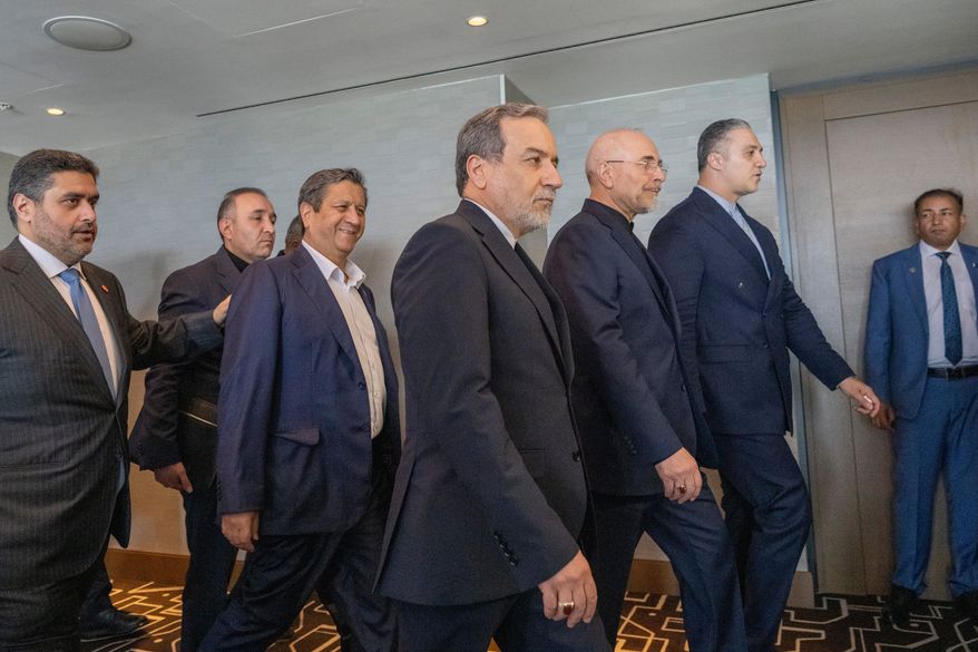 Minister of Foreign Affairs of Iran Abbas Araghchi, third from right, and Speaker of the Islamic Parliament of Iran Mohammed Bagher Ghalibaf, second from right, with the Delegation of Iran at the Lake Lucerne Summit at the Buergenstock resort in Obbuergen, near Lucerne, Switzerland, Sunday, June 21, 2026. (Urs Flueeler, Pool Photo via AP)